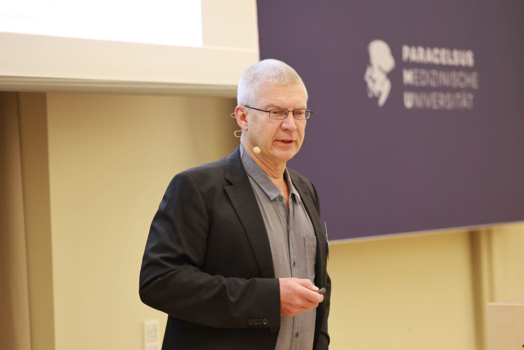 Foto: Dr. Bernd Herrmann (Klinikum Kassel) während seines Vortrags zum Thema „Medizinhistorischer Streifzug: von Tardieu und Kempe bis zur DGKiM und der Kinderschutzmedizin heute“. © F. Neumayr